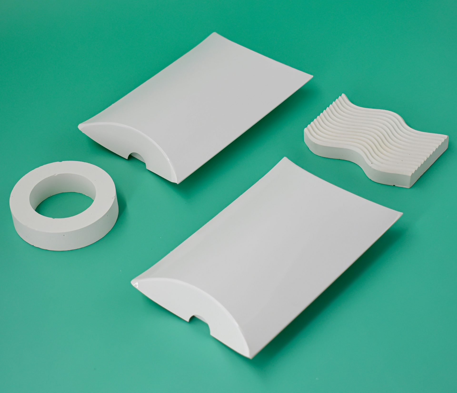 a couple of pieces of white plastic sitting on top of a green surface